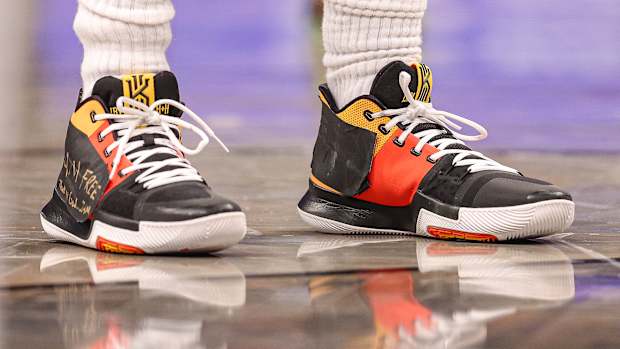 View of black and red Nike Kyrie shoes.